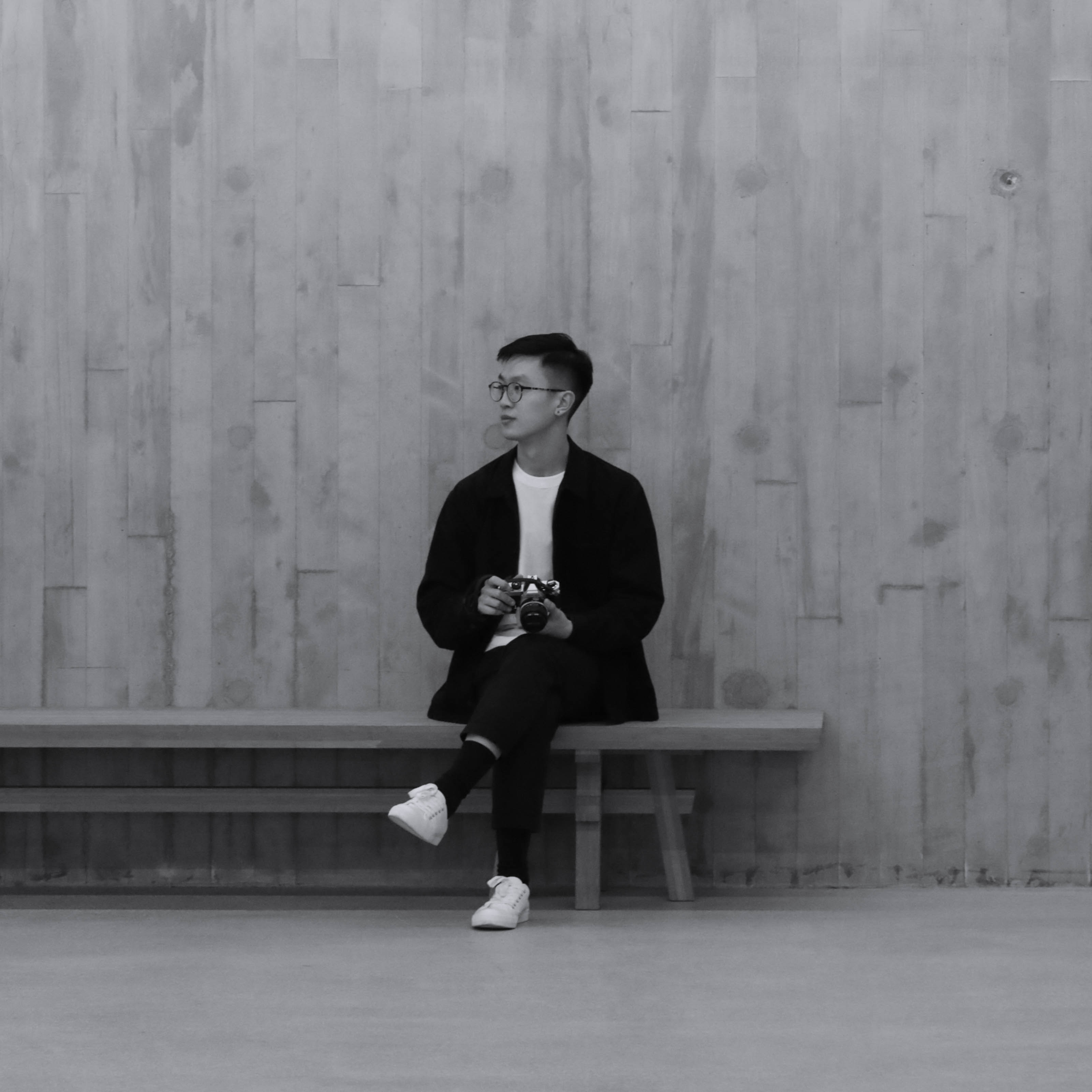 Justin sitting for a black and white portrait.