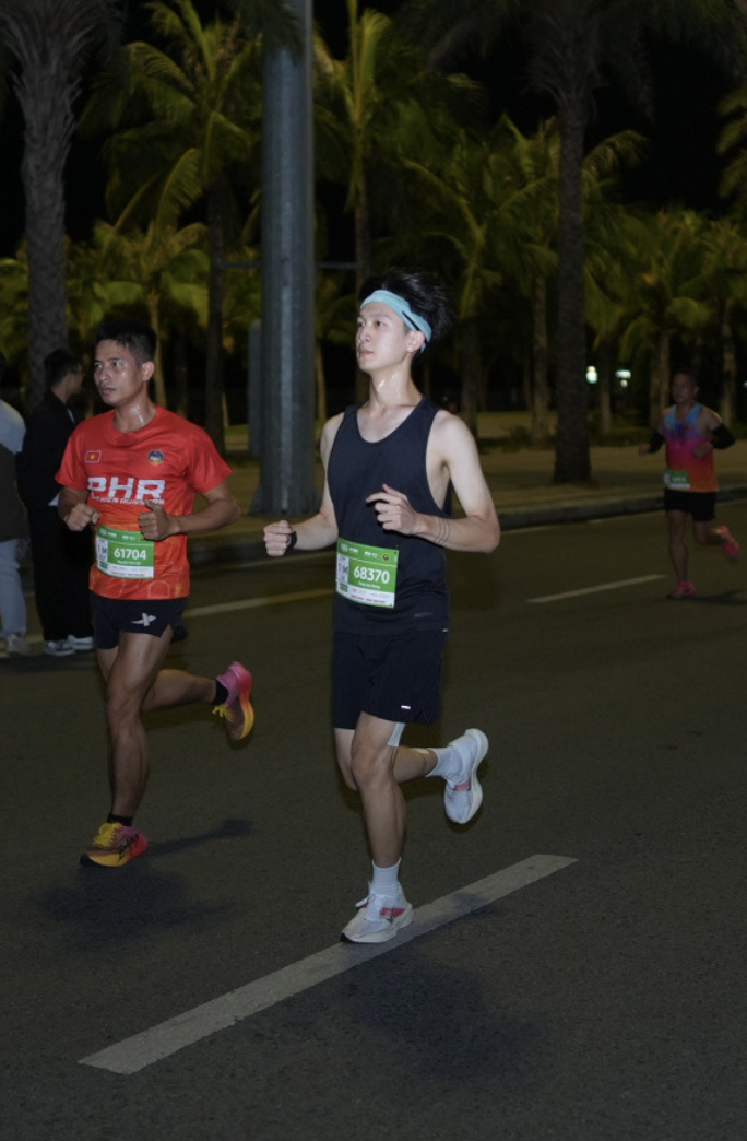 Justin running outdoors with another runner.